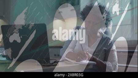 Image of statistical data processing against biracial senior woman taking notes at home Stock Photo