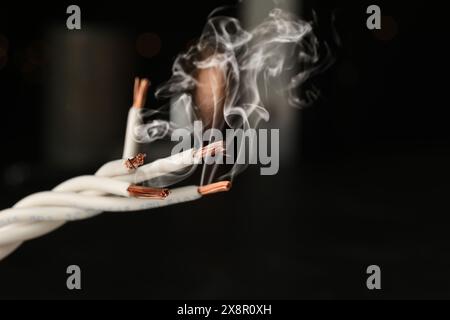 Wiring with smoke on dark background, closeup Stock Photo