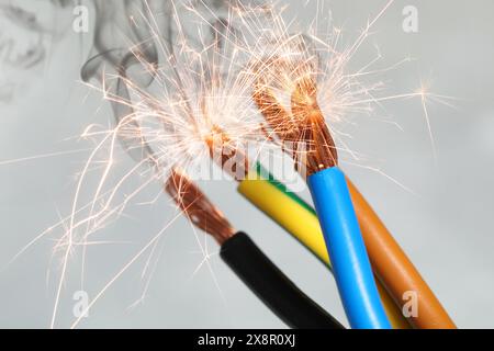 Sparking wiring on blurred background, closeup view Stock Photo
