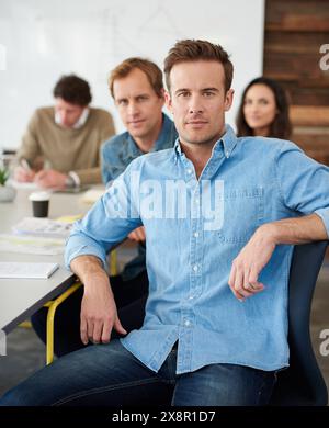 Meeting, serious and portrait of businessman in office planning creative project with teamwork. Confident, discussion and copywriter with group of Stock Photo
