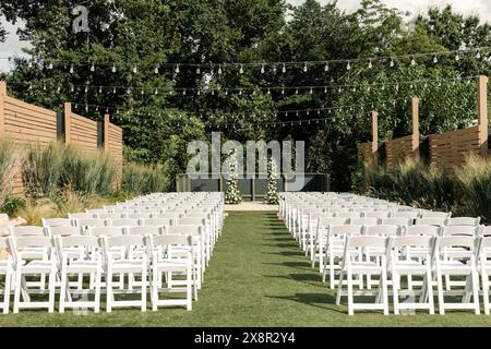 Outdoor wedding setup with chairs and lights Stock Photo