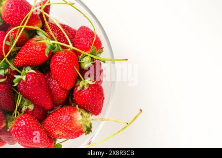 Top view of strawberries in glass bowl on white background Stock Photo