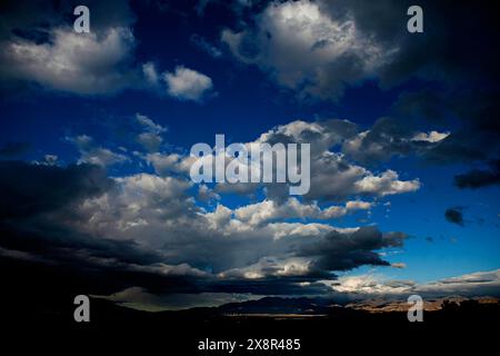 Majestic blue cloudscape over mountain range. Stock Photo