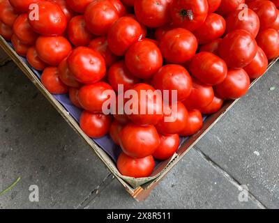 Close-up of a box of red tomatoes at an outdoor market in Queens, NY Stock Photo