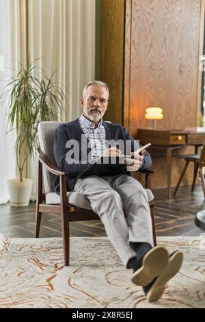 elegant middle aged male expert sitting in office Stock Photo