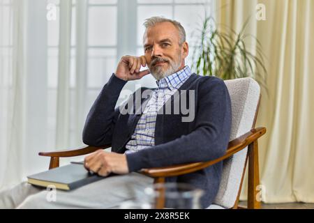 elegant middle aged male expert sitting in office Stock Photo