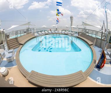 (240527) -- SHANGHAI, May 27, 2024 (Xinhua) -- This photo taken on May 26, 2024 shows an outdoor swimming pool on the cruise ship Adora Magic City docking at the Shanghai Wusongkou International Cruise Terminal in east China's Shanghai. Since its maiden voyage at the beginning of year, China's first domestically built large cruise ship Adora Magic City has completed 34 journeys and received nearly 150,000 tourists so far.   The cruise ship is 323.6 meters in length, has a gross weight of 135,500 tonnes, and can accommodate up to 5,246 passengers across a total of 2,125 guest rooms. The number Stock Photo