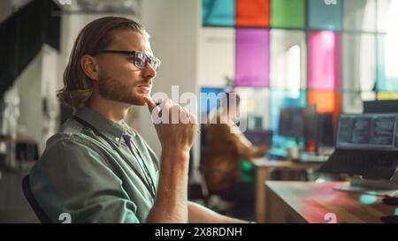 Professional Male Programmer Writing Code on Desktop Computer With Multiple Displays Setup in Stylish Office. Caucasian Man Does Data Scraping For Artificial Intelligence Innovative Start-Up. Stock Photo