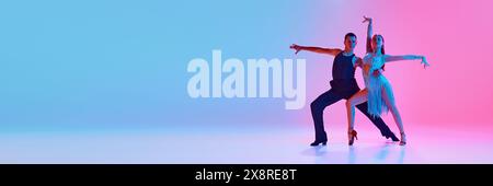 Banner. Young ballroom dancers practicing dance moves in stages costumes in neon lighting against gradient background. Stock Photo