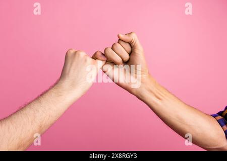 Photo of two people making peace promise gesture isolated pastel color background Stock Photo