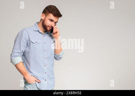 Handsome man talking on cellphone and smiling Stock Photo