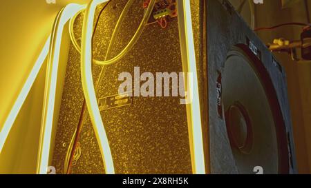 LED strip in interior. Creative. Close-up of luminous ribbon on sound column. Details of old interior with modern luminous ribbon Stock Photo