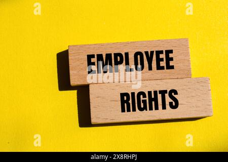 Employee rights words written on wooden blocks with yellow background. Conceptual employee rights symbol. Copy space. Stock Photo