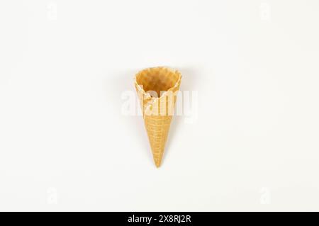 Top view of ice cream waffle cone on white background. Summer wallpaper, flat lay, copy space. Stock Photo