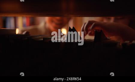 Young woman and man are choosing books in library. Stock footage. Beautiful young couple of students at library. Happy couple in love have fun Stock Photo