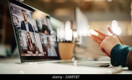 Multiethnic People Conference Meeting Online and Discussing Business Project. Laptop Screen Containing a Group Video Call. Colleagues Working From Home and Collaborating on Internet Stock Photo
