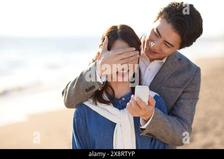 Japanese man proposing to girlfriend at the beach Stock Photo - Alamy