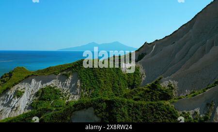 Beautiful aerial of the white cliffs on the south coast of England. Clip. Green summer forested hills and blue sky. Stock Photo