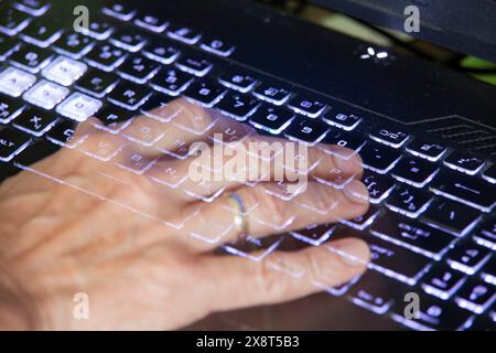 Close-up view of men's hands typing on a laptop. Relevance. Working from home, writer creating an article, browsing the internet using modern wireless Stock Photo