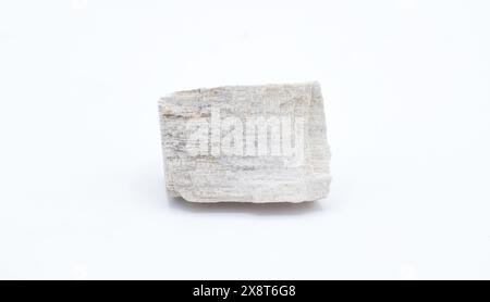 Cut out gypsum satin spar mineral rock isolated on white background. Gypsum is a soft sulfate mineral composed of calcium sulfate dihydrate, with the Stock Photo