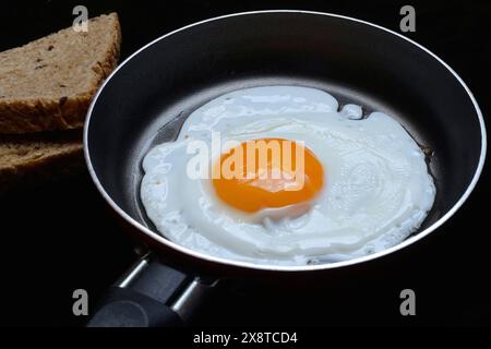 Fried egg in a pan, fried chicken egg Stock Photo