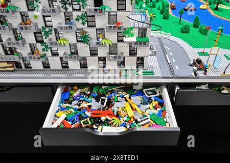 Drawer toy building blocks and Lego apartment block with surroundings Stock Photo