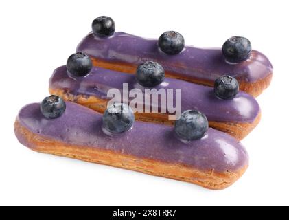 Delicious eclairs decorated with blueberries isolated on white Stock Photo