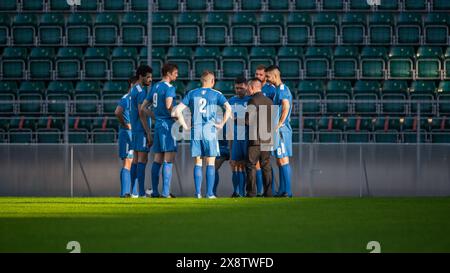 Professional Soccer Team Training, Tactical Coaching: Football Coach Explains Game Strategy, Tactics, Workout Plan to Players. Trainer Motivates Athletes, Leads to Victory, Preparing For Tournament Stock Photo