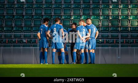 Professional Soccer Team Training, Tactical Coaching: Football Coach Explains Strategy, Tactics, Workout Plan to Players. Trainer Motivates Athletes, Leads to Victory, Preparing For Tournament Stock Photo