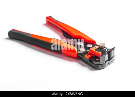 Tool equipment, steel metal repair pliers, white stripper stripping object. Wire industry instrument, crimp mechanic jaws red background. Work network Stock Photo