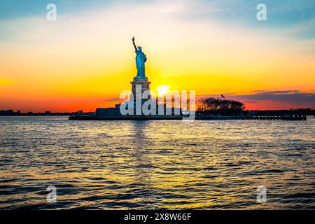 New York. Manhattan. United States. The Statue of Liberty on Liberty Island at sunset Stock Photo