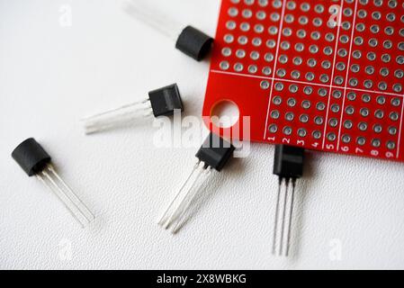 Red printed circuit board and chips and radio components. Capacitors and transistors. Stock Photo