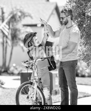 father and son outdoor. having fun. father and son enjoying a bicycle ride together. active son and father duo cycling through scenic countryside on Stock Photo