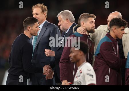 Dublin, Ireland. 22nd May, 2024. Fernando Carro CEO of Bayer 04 Leverkusen emrbaces Robert Andrich of Bayer Leverkusen and Paul Cooke President of the FAI shakes hands with Xabi Alonso Head coach of Bayer Leverkusen during the trophy presentation ceremony following Atalanta BC's 3-0 victory in the UEFA Europa League match at the Aviva Stadium, Dublin. Picture credit should read: Jonathan Moscrop/Sportimage Credit: Sportimage Ltd/Alamy Live News Stock Photo