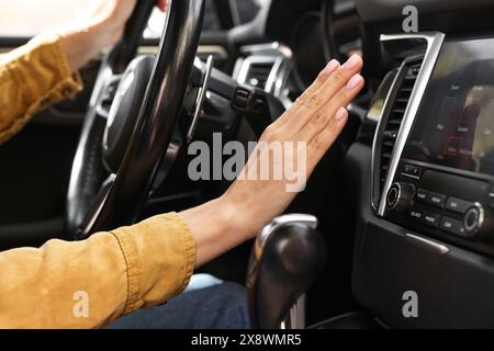 Woman checking air conditioner in her car, closeup Stock Photo