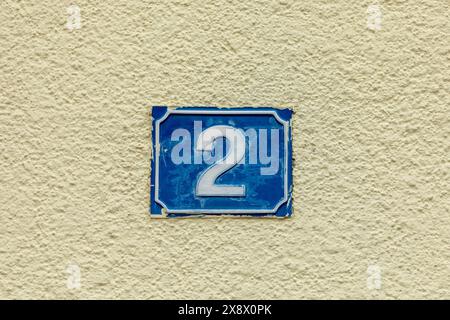 house number 38 in metal at white painted plaster wall in vintage style Stock Photo