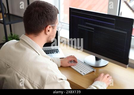 Focused male programmer working in office Stock Photo