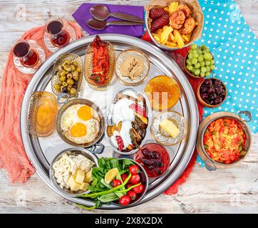 Traditional Turkish Breakfast served with traditional turkish tea on wooden table. Turkish traditional village breakfast. Stock Photo