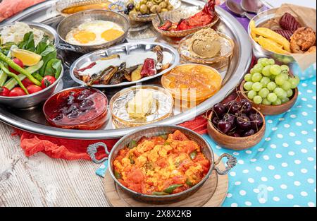 Traditional Turkish Breakfast served with traditional turkish tea on wooden table. Turkish traditional village breakfast. Stock Photo