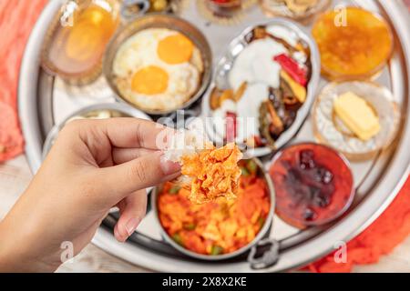 Traditional Turkish Breakfast served with traditional turkish tea on wooden table. Turkish traditional village breakfast. Stock Photo