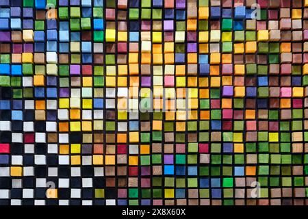 A colorful mosaic made of wood blocks. The blocks are arranged in a way that creates a pattern of squares and rectangles. The colors are bright and vi Stock Photo