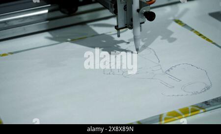 Automated machine draws image on paper. Media. Robotic machine that ...