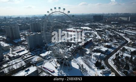 Top view of big Ferris wheel in winter. Creative. Beautiful urban landscape with Ferris wheel in city center in winter. Ferris wheel in center of big Stock Photo