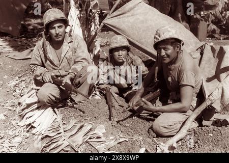 Navajo code talkers with the first assault waves of the U.S. Marine Corps to hit the beach on Saipan in the North Mariana Islands in 1940s during World War II. Stock Photo