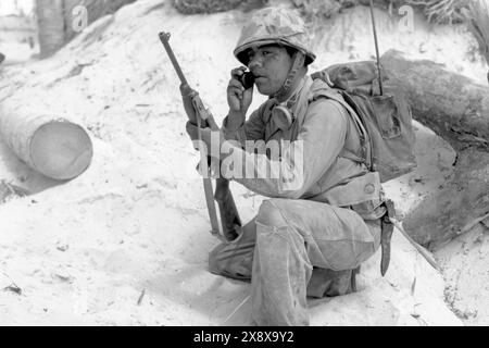 U.S. Marine Corps Navajo code talker communicating by walkie-talkie in November 1943 during World War II. Stock Photo