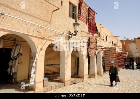 Carpets hanging outside of traditional dwellings for sale in the main square of Ghardaial.Mzab Valley.Ghardaia Province.North Sahara.Algeria Stock Photo