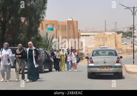 Female students wearing hijab walking on the street during a school lunch break.Ghardaia.Mzab valley.Ghardaia Province.north Sahara.Algeria Stock Photo