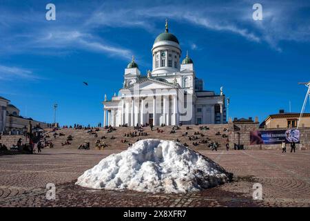 Melting snow pile on Senate Square with Helsinki Cathedral in the background on May Day Eve in Kruununhaka district of Helsinki, Finland Stock Photo