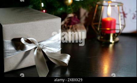 New Year's holiday, Christmas Eve at home with a Christmas tree, candles, postcards, handouts, gifts, present, boxes, laptop, phone. Workplace Stock Photo