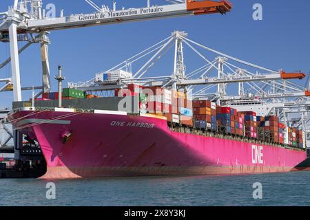 Le Havre, France - View on the container ship ONE HARBOUR alongside at port of Le Havre with ship to shore container cranes. Stock Photo